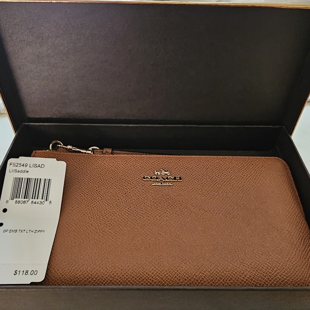 Authentic COACH tan leather wristlet.